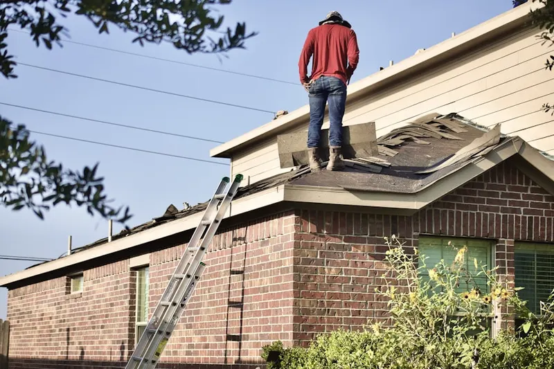 Professional roofer working on a residential roof in South of Main